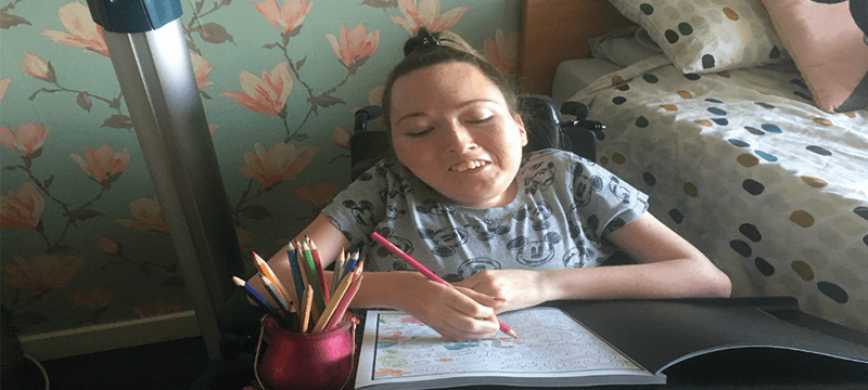 Image of Claire colouring in at home.