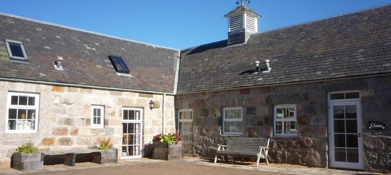 Photo showing the exterior of a cottage at Crathie Opportunity Holidays.
