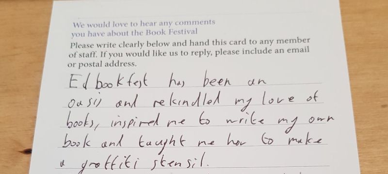 A filled in feedback form on a wooden surface.