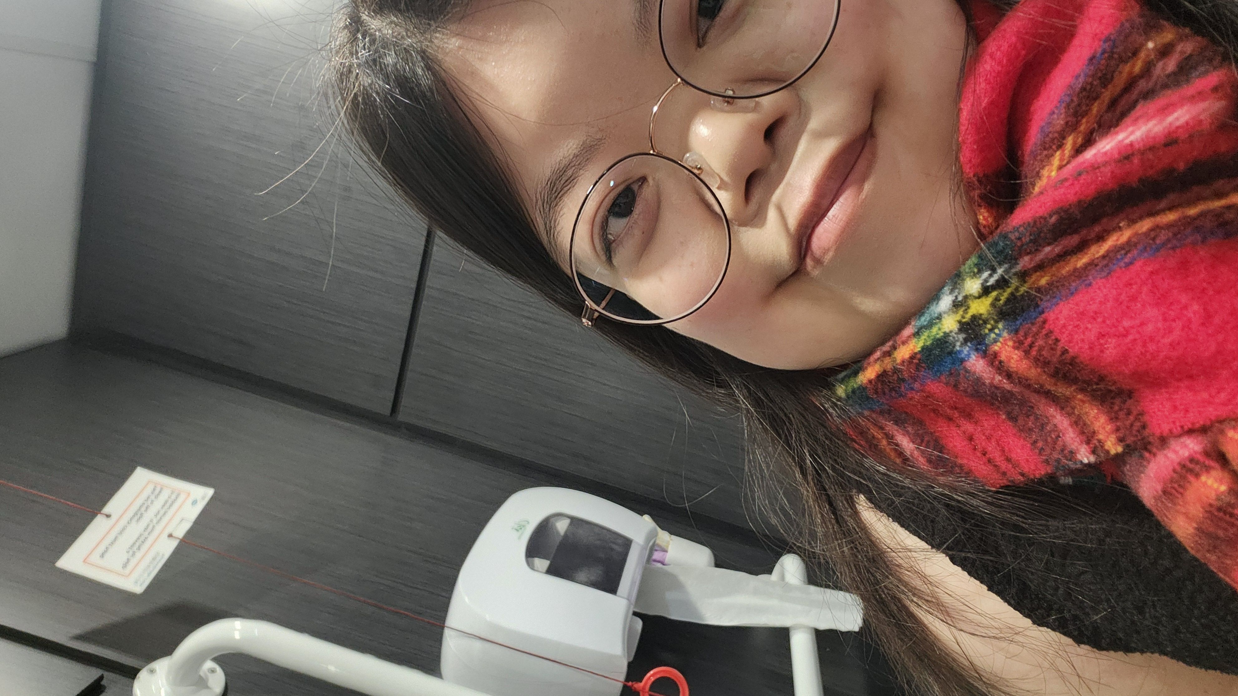 A selfie of Haneul with a Red Cord Card attached to a red emergency cord.