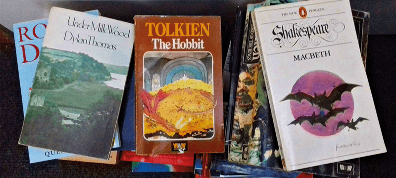 Three piles of books by a door